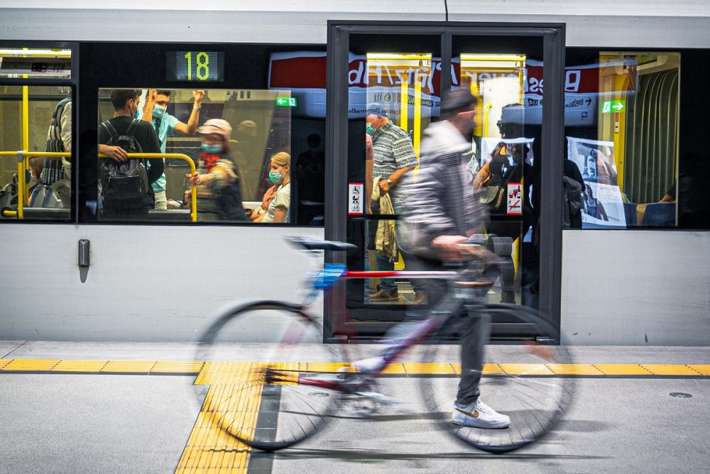 commuter walking with bike on subway platform